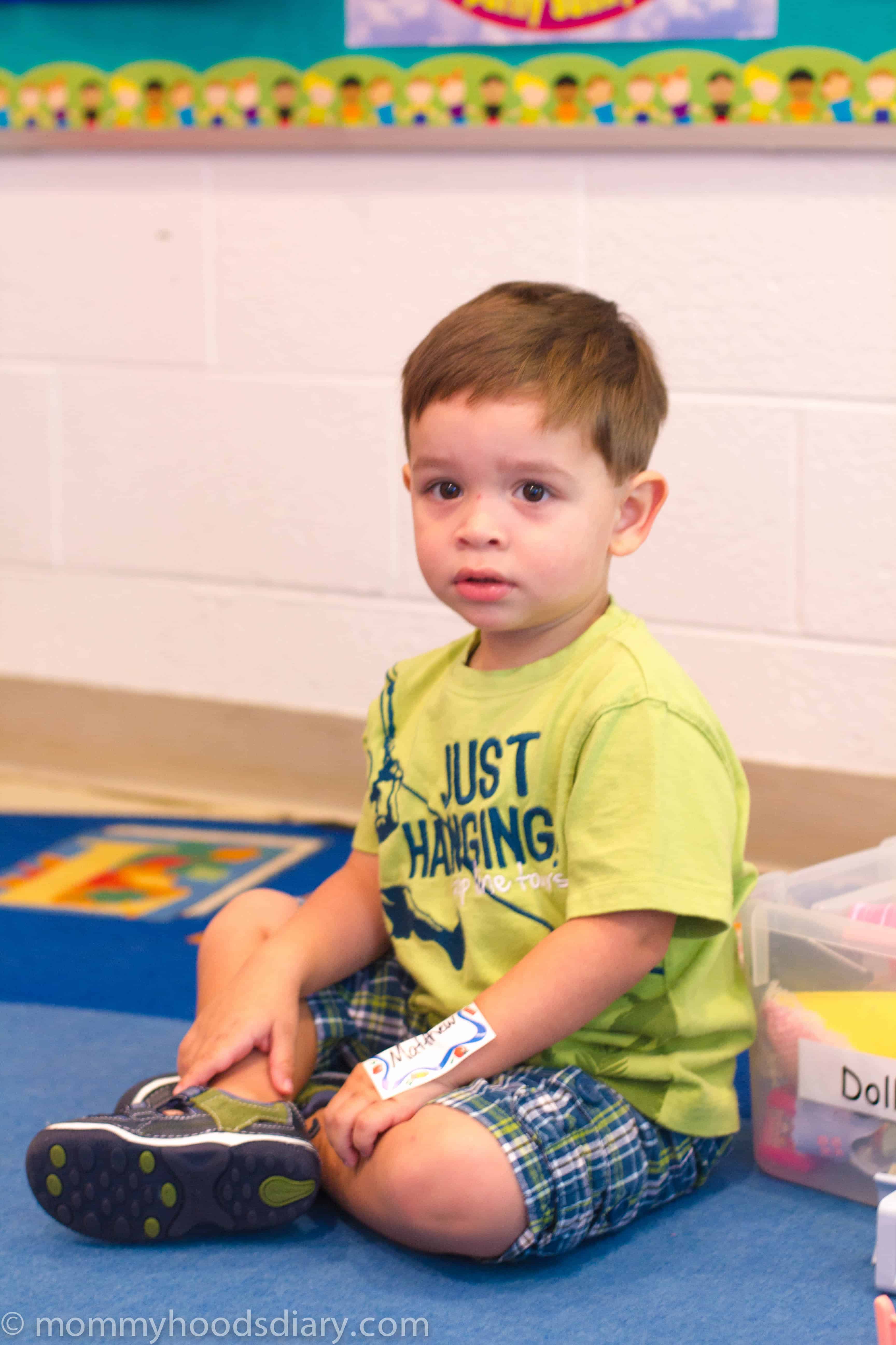 boy seated at the floor 