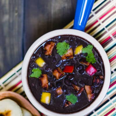 Venezuelan Black Bean Soup in a bowl served with arepas