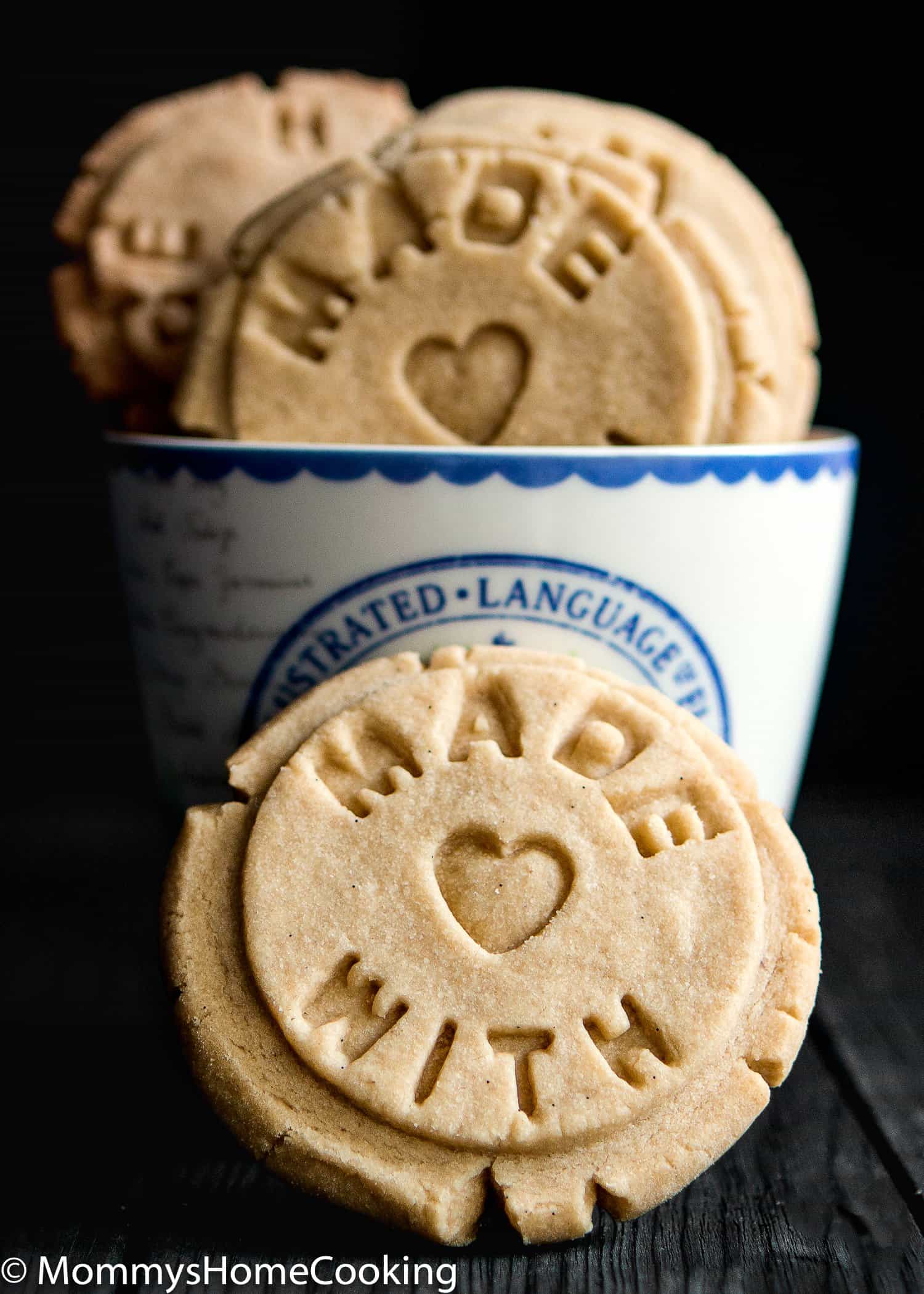 Easy Eggless Vanilla Cookie with a cup in the back.