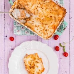 Overhead view of a serving of pasticho cut from a casserole dish.