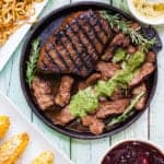 GRILLED BALSAMIC-GARLIC STEAK on a cast iron skillet with cilantro mojo.