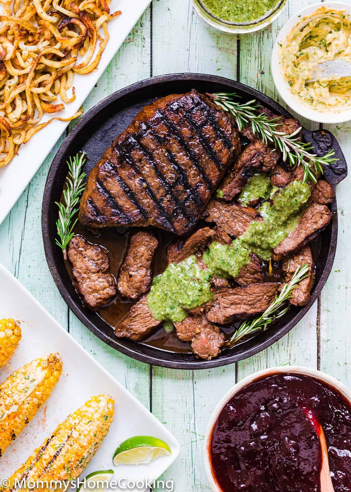 GRILLED BALSAMIC-GARLIC STEAK on a cast iron skillet with cilantro mojo