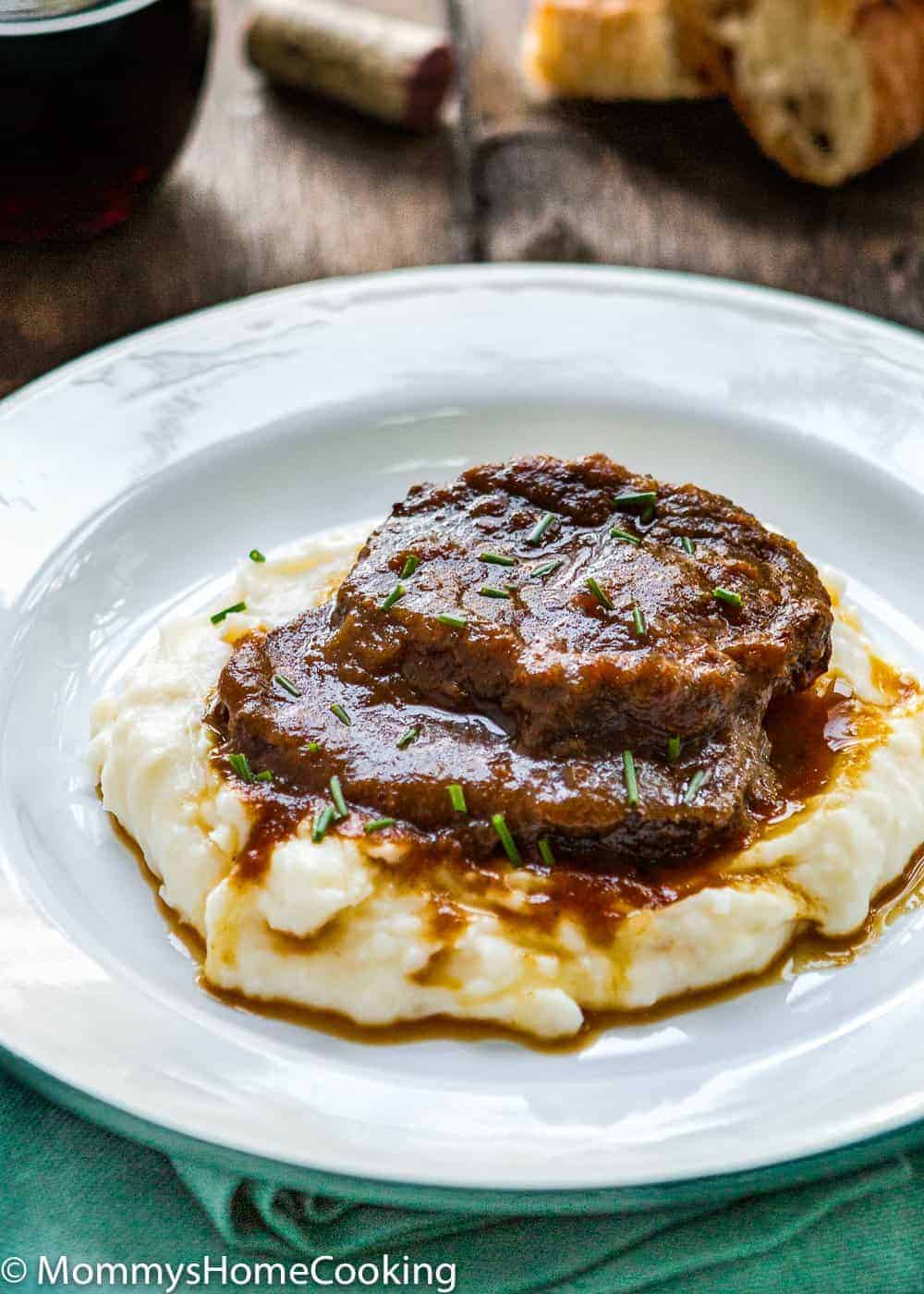 Venezuelan Asado Negro in a white plate with mashed potatoes 