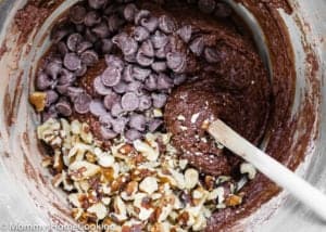 eggless healthy double chocolate chunk walnut cookies dough in a bowl with a spatula