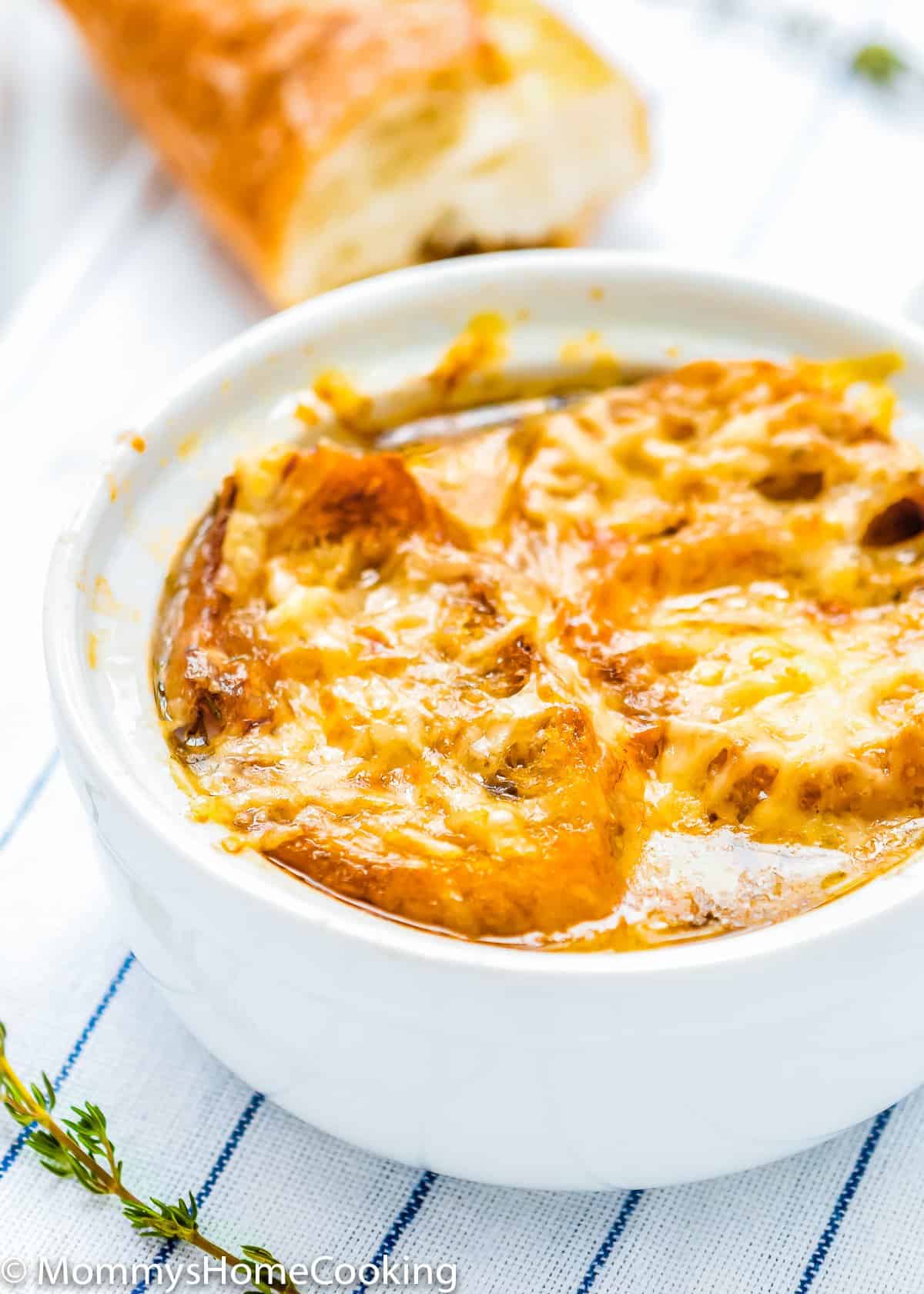 onion soup in a bowl with melted cheese and bread