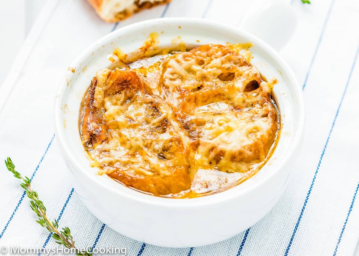 onion soup in a bowl with melted cheese and bread on top