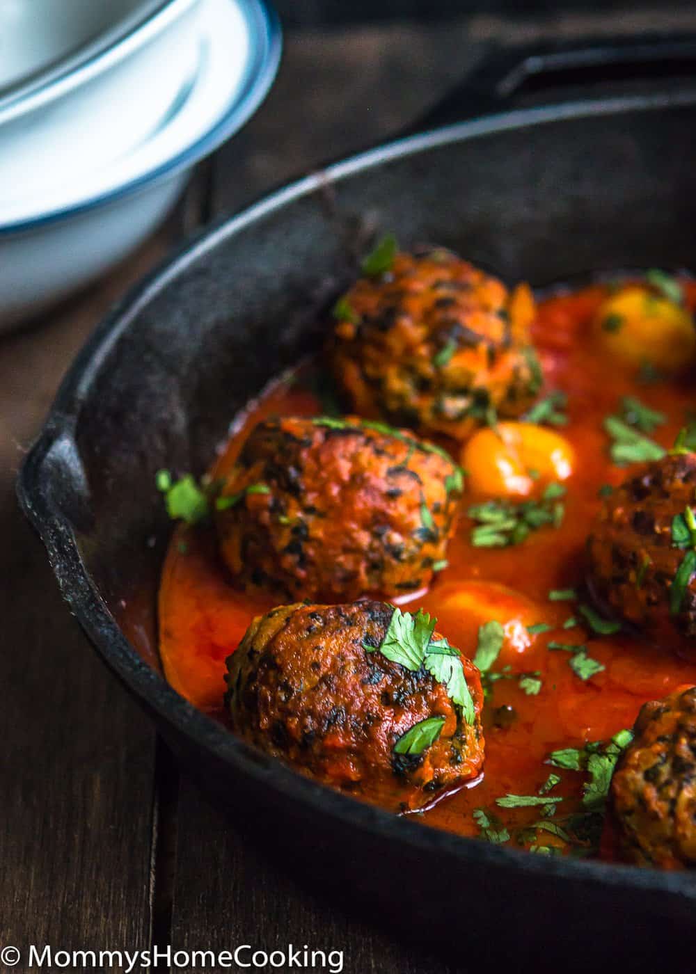 Easy Eggless turkey meat balls in a cast iron skillet with sauce.