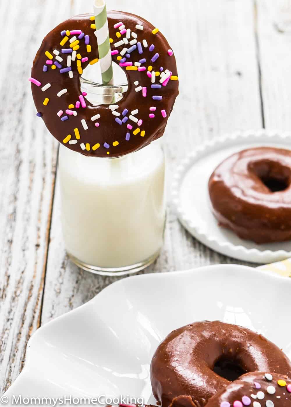 Easy Eggless Chocolate Donuts with chocolate glaze and a cup of milk