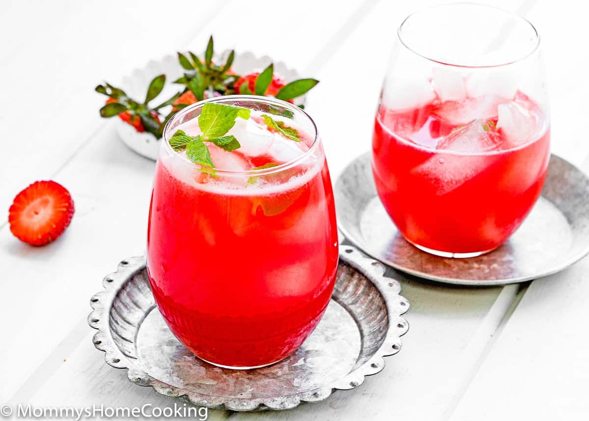 two glasses of homemade Strawberry lemonade over a wooden surface