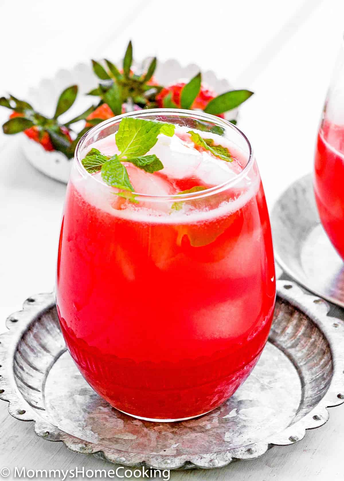 homemade Strawberry lemonade in a glass on a metal plate