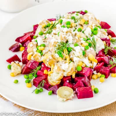 Venezuelan-Style Beet and Potato Salad on a plate with peas and dill