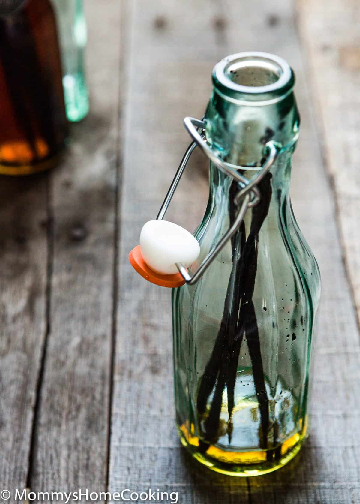 a glass bottle with vanilla beans inside