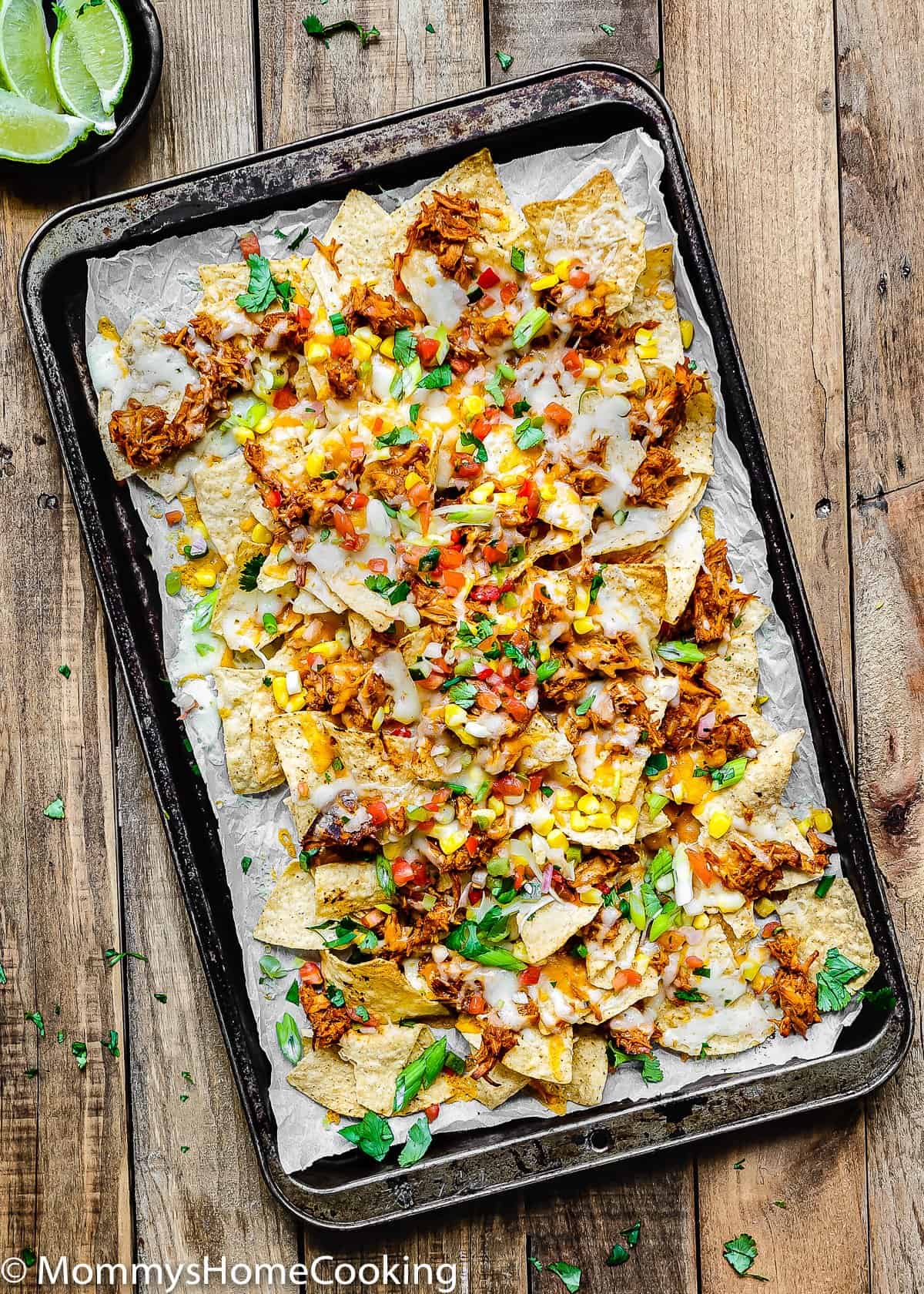 overhead view of Tequila Barbecue Chicken nachos on a baking sheet
