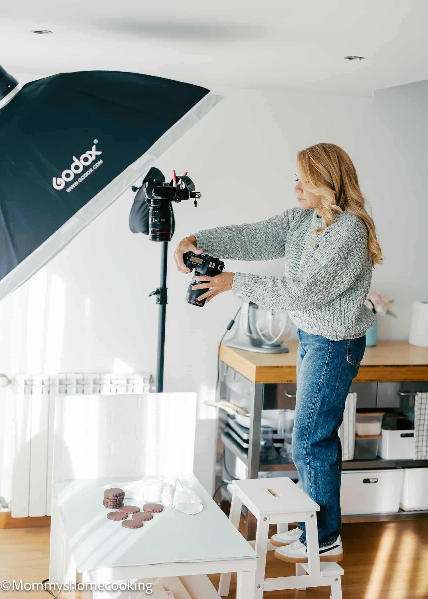 oriana from mommyshomecooking.com taking photos in her studio.