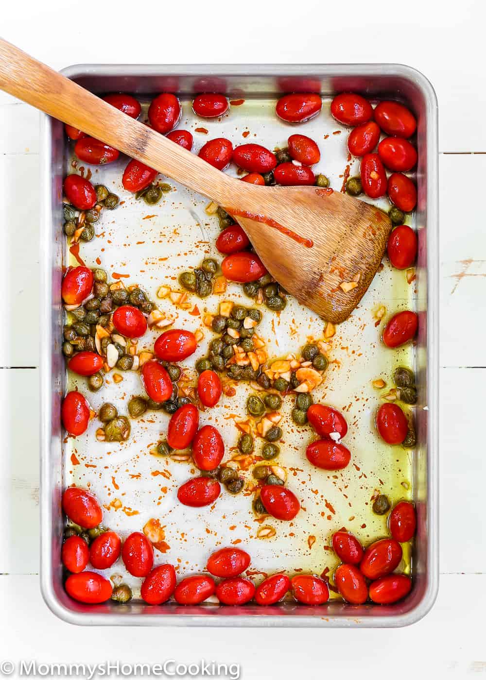 roasted tomatoes and cappers in a baking pan