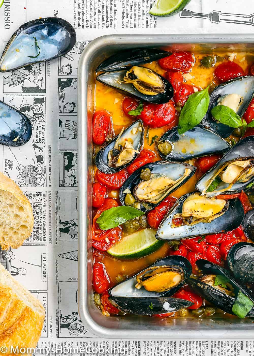 baked mussel with tomatoes, and cappers in a baking pan