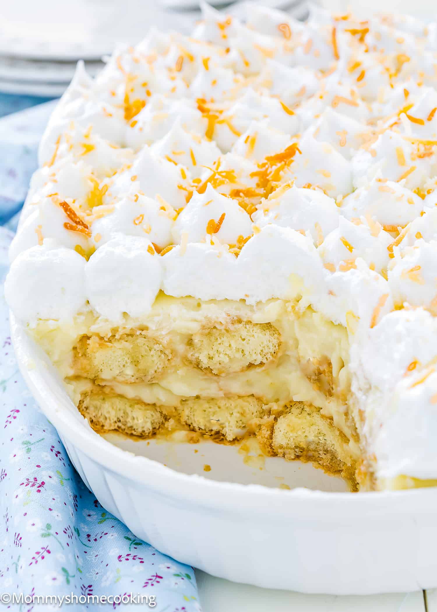 Closeup of a Venezuelan Bienmasabe in a serving dish topped with merengue and toasted coconut.