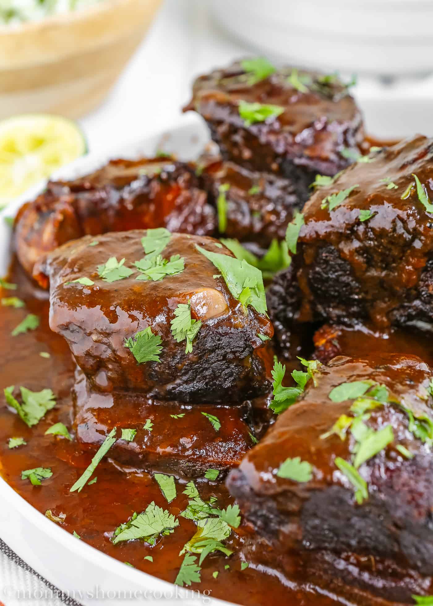 Close up of short ribs garnished with cilantro.