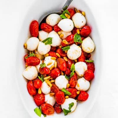 overhead view of a ROASTED TOMATO CAPRESE SALAD in a bowl