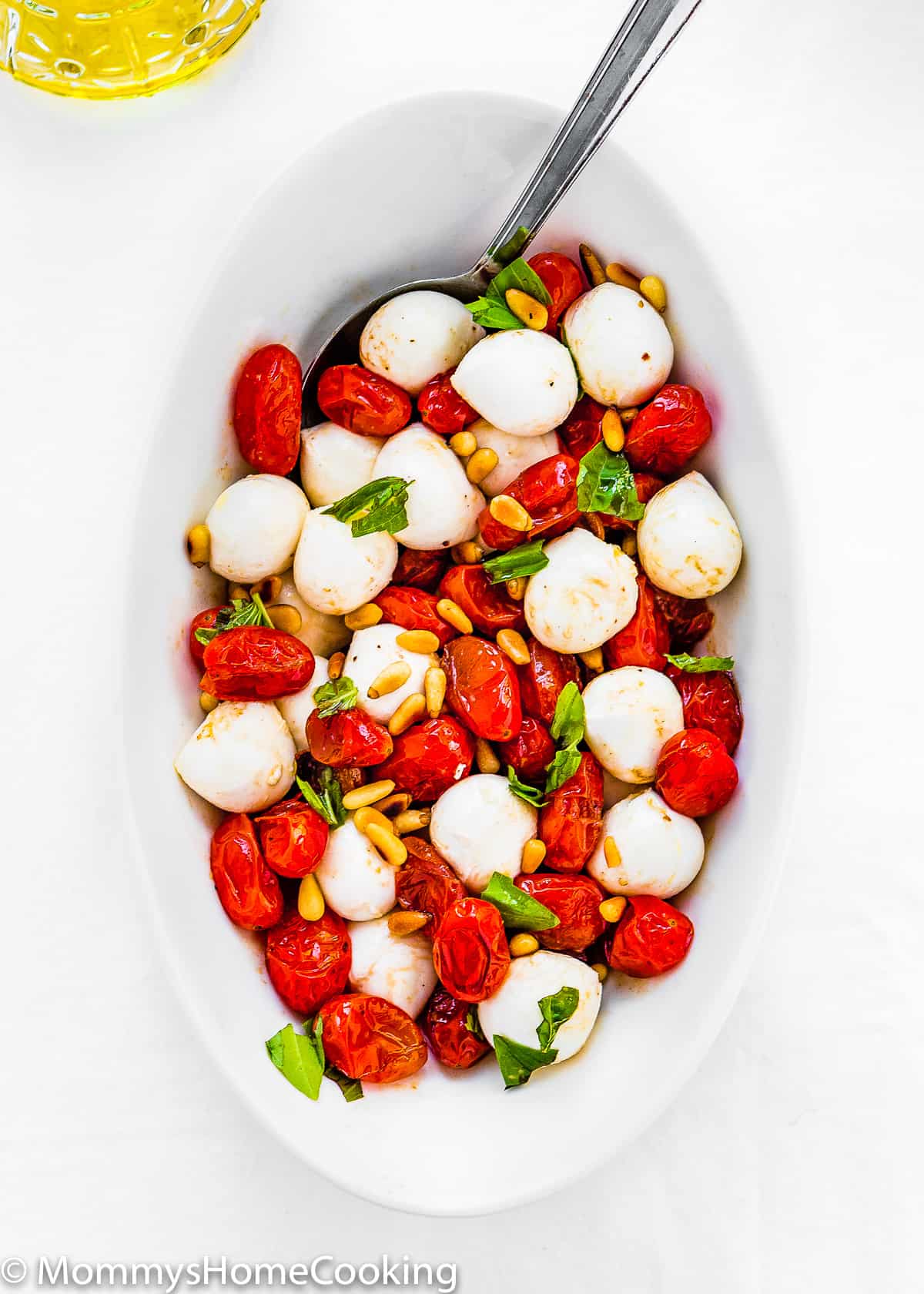 overhead view of a ROASTED TOMATO CAPRESE SALAD in a bowl