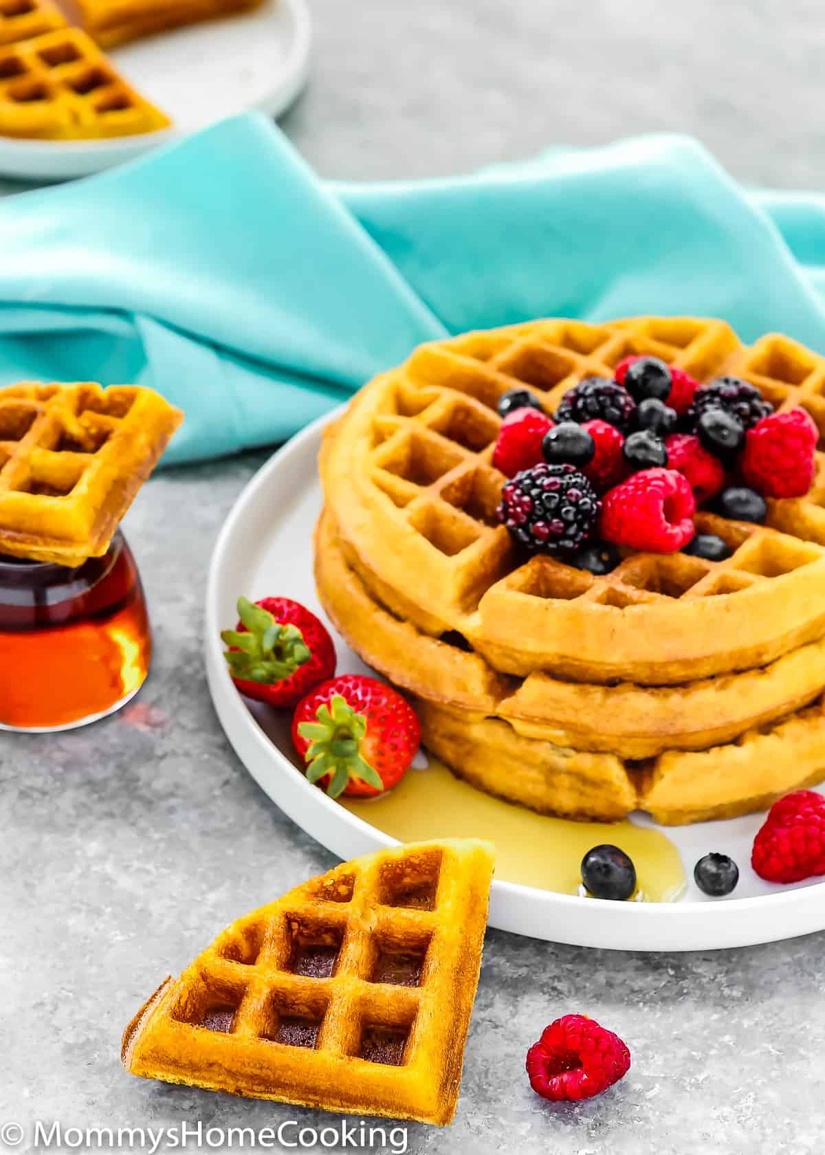 eggless waffles stack with fresh fruit on a gray surface