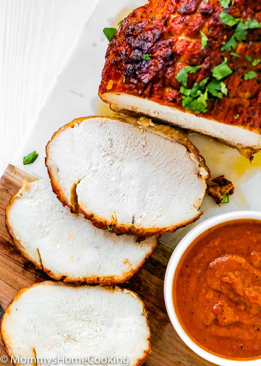slices of sliced Chipotle Turkey Breast Roast  over a cutting board