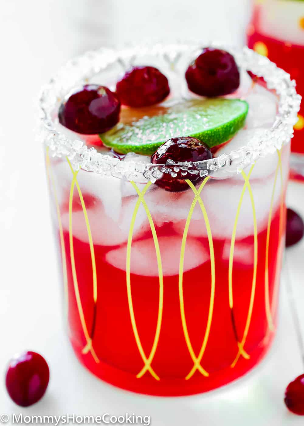 roasted cranberry margarita in a glass with a lime wedge