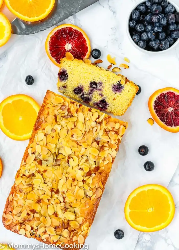 Sweet Eggless Orange Blueberry Corn Bread loaded with blueberries and sprinkled with almonds. The corn-citrus combination is so yummy and perfect for breakfast or snack time. Totally irresistible! https://mommyshomecooking.com