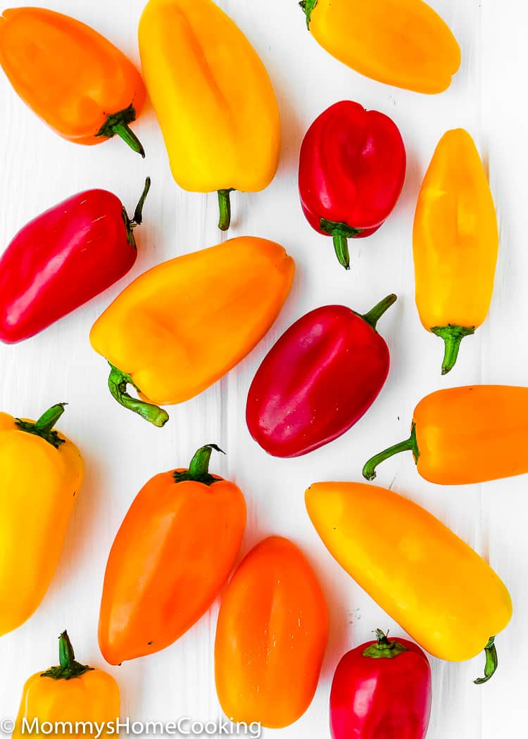 mini sweet peppers over a white surface. 