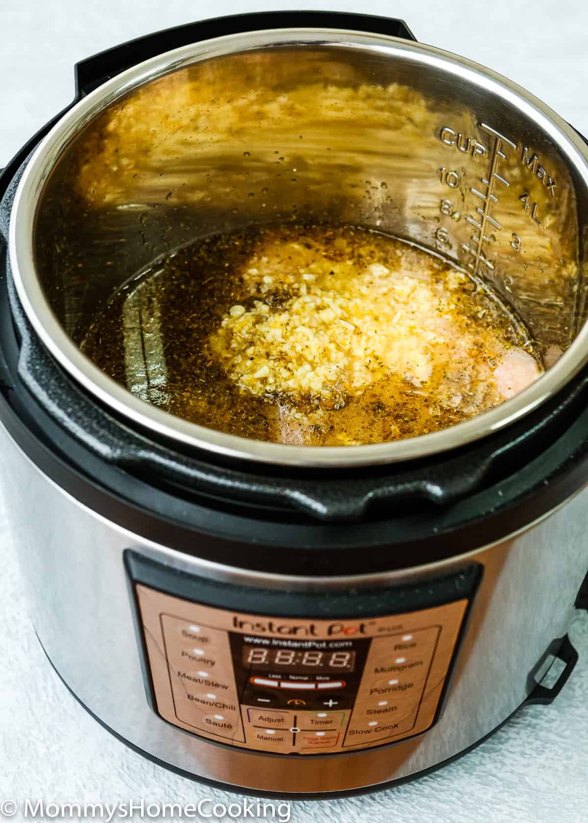 chicken breasts and mojo sauce in a pressure cooker pot.