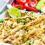 Mojo Chicken with cilantro and lemon wedges