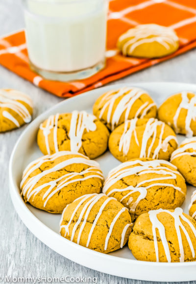Eggless Pumpkin Cookies on a plate with a glass of milk on the background
