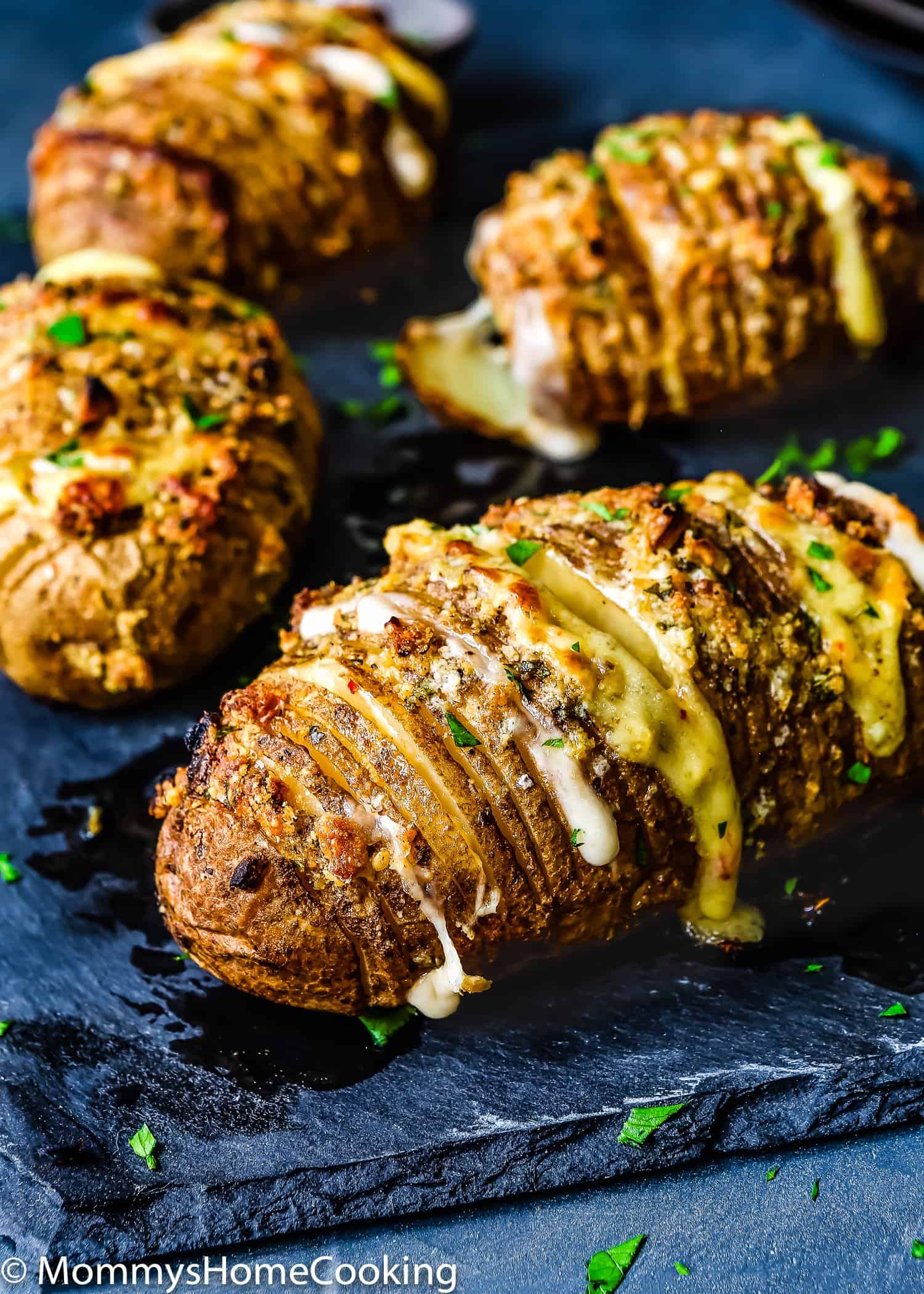 Easy Cheesy Garlic Hasselback Potatoes on a stone serving plate.
