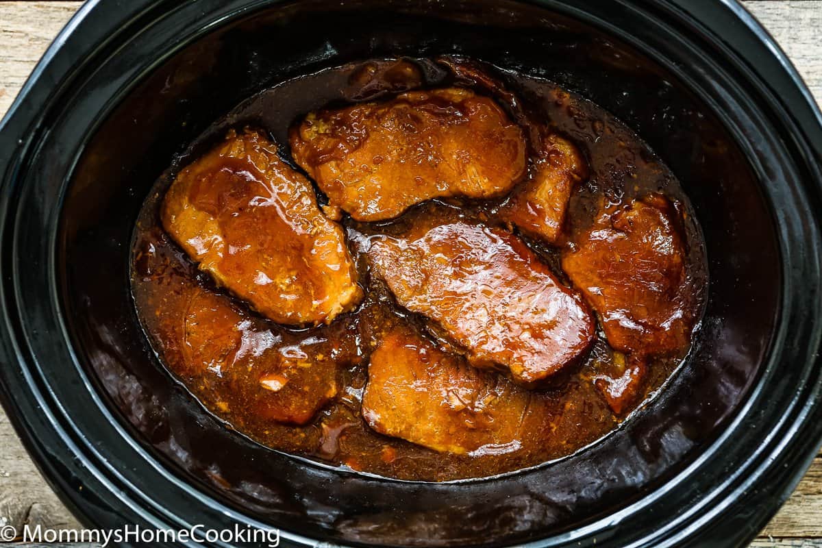 Honey Garlic Pork Chops with sauce in a slow cooker.