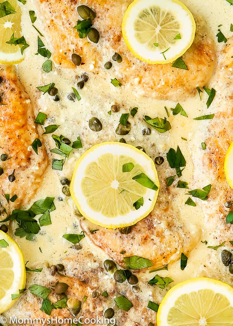 creamy chicken piccata garnished with parsley and lemon slices