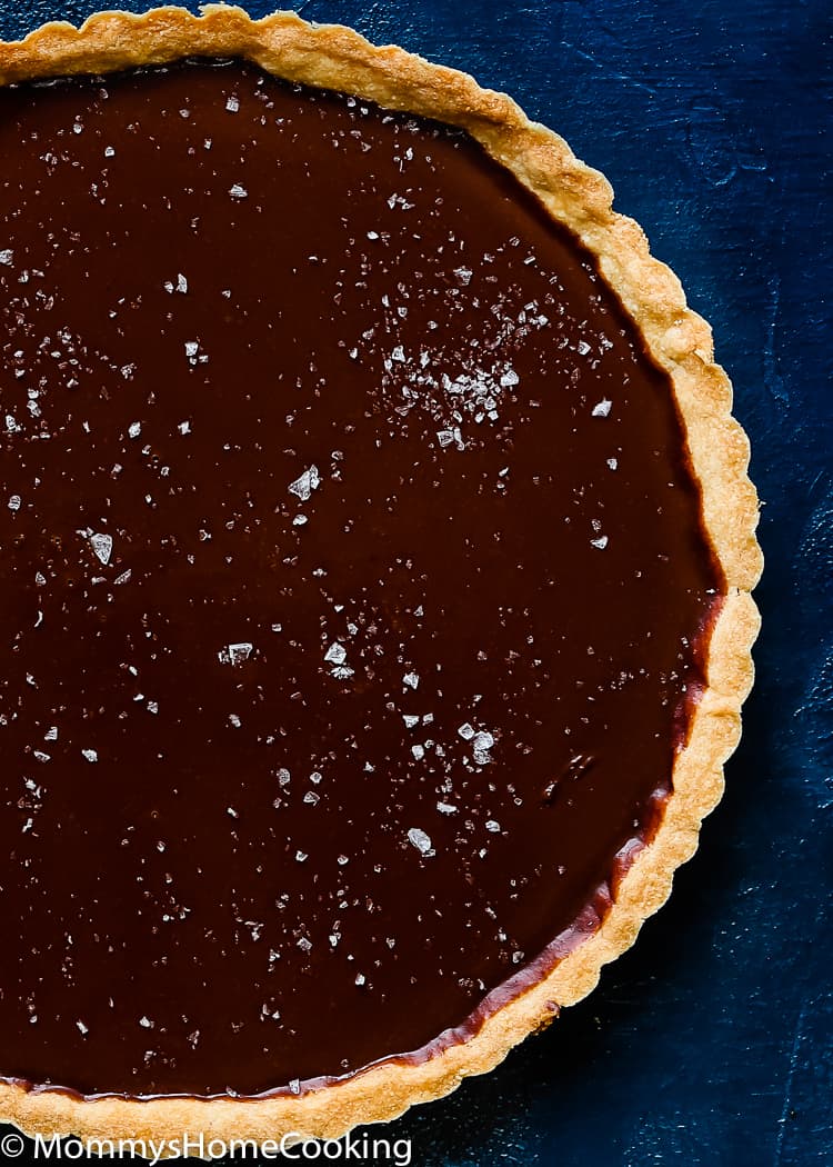 This Easy Eggless Chocolate Tart is a ridiculously easy and scrumptious dessert! The flavors of the rich chocolate filling and the buttery flaky crust meld together like no other. You have to taste it for yourself. https://mommyshomecooking.com