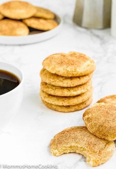 Eggless Snickerdoodle Cookies over a marble surface with a cup of coffee on the side