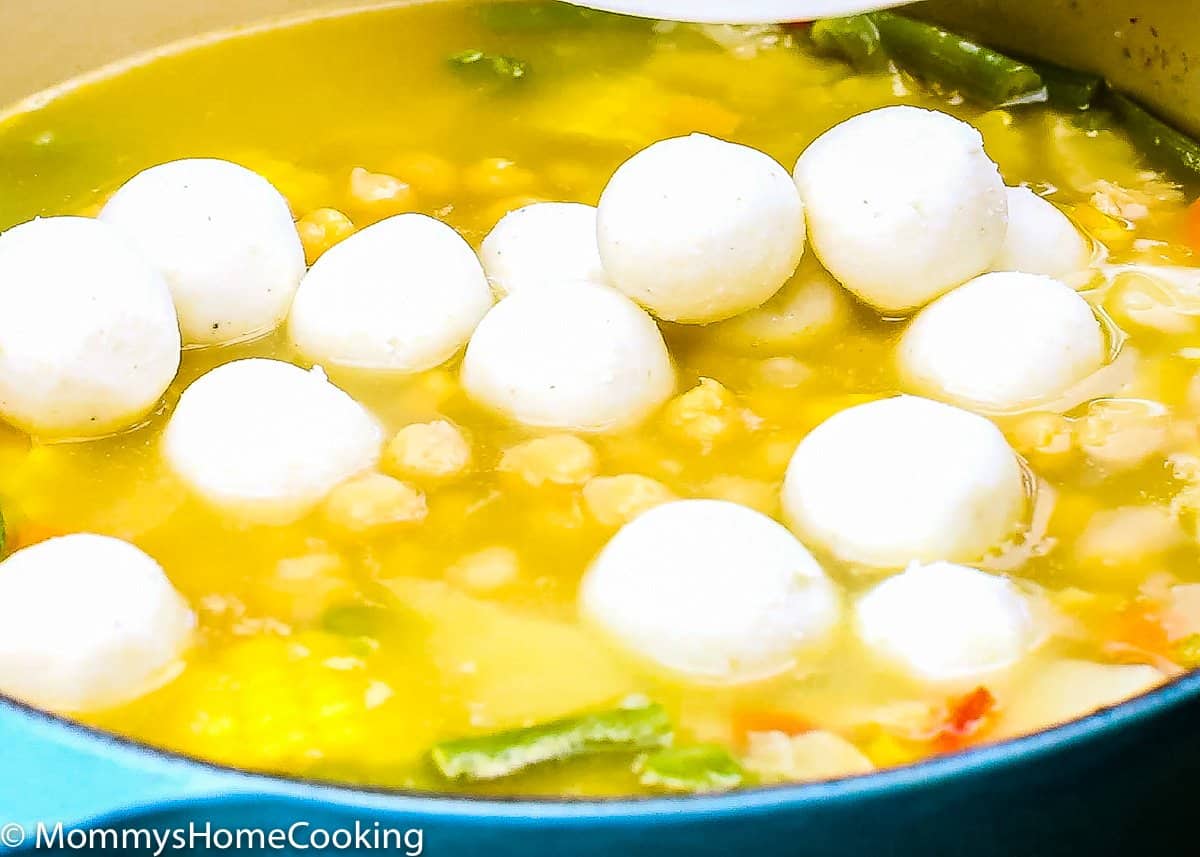 pot with broth, veggies and masa balls to make Venezuelan mondongo.