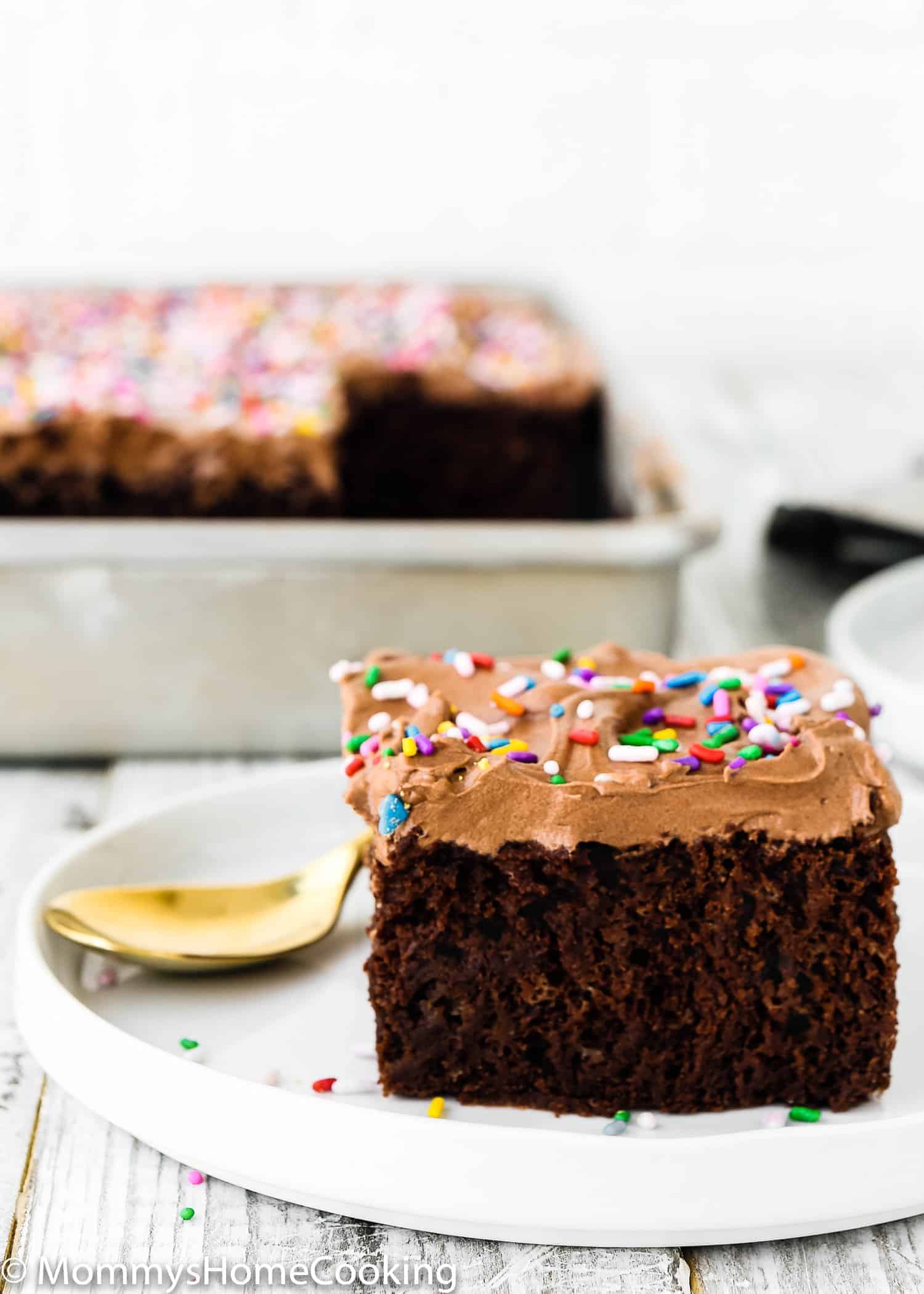 Close up of a moist fluffy slice of eggless chocolate cake.