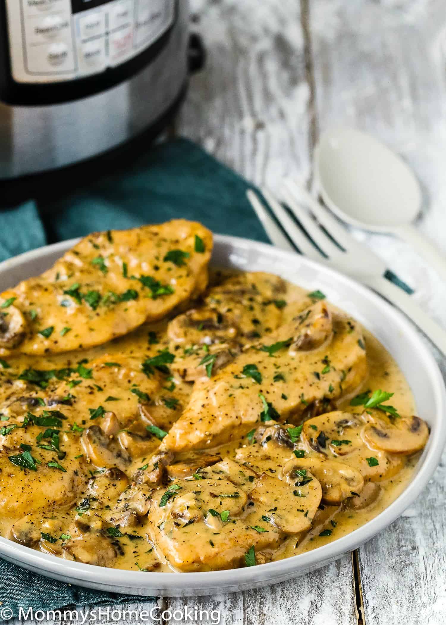 Creamy Chicken Marsala made in the instant pot over a serving plate.
