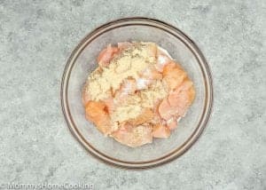chicken breast with salt, pepper and powder garlic in a bowl