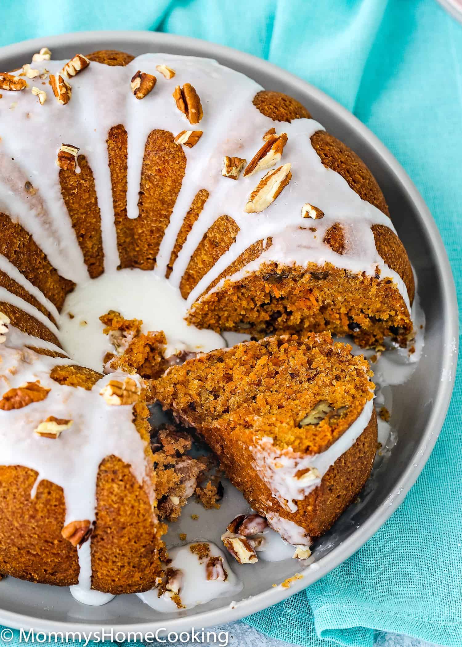 Eggless Carrot Cake over a serving plate with glaze 