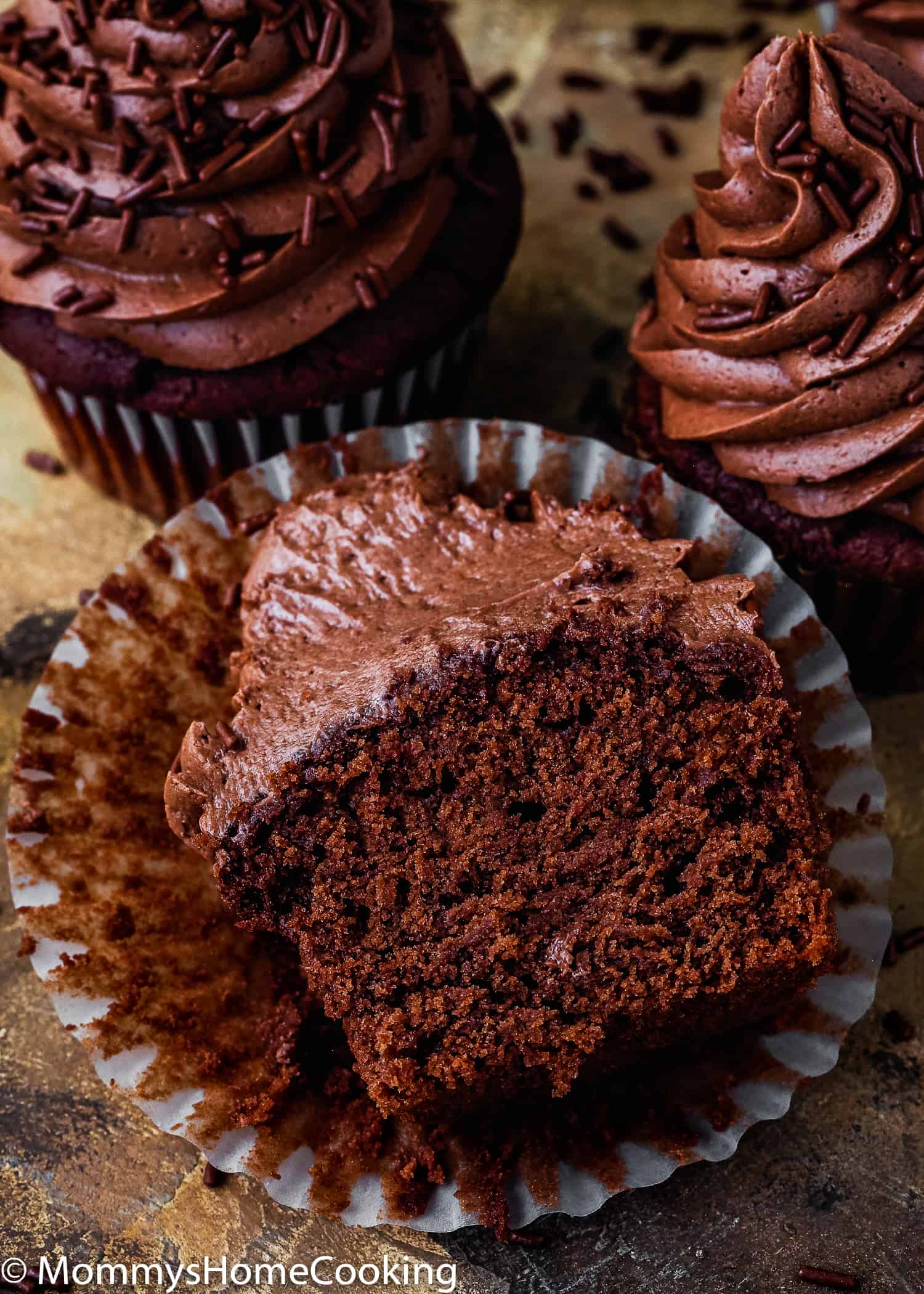 Eggless Chocolate Cupcake cut in half showing its fluffy texture. 