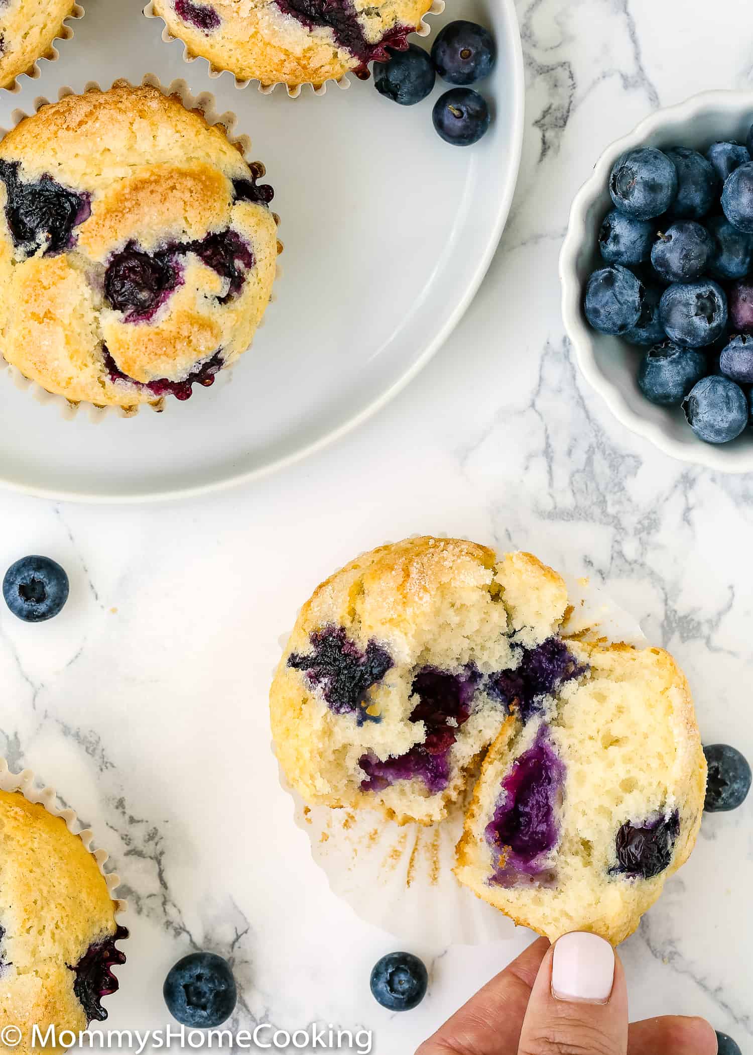 Eggless Blueberry Muffins cut open showing the fluffy inside texture.