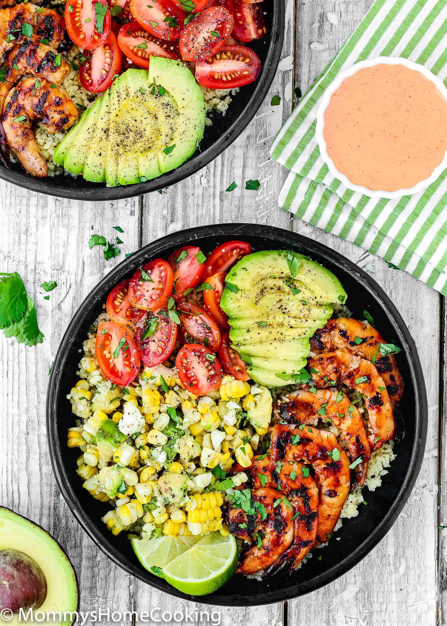 This Grilled Barbecue Shrimp and Corn Avocado Salad Bowls recipe is delicious, incredibly tasty and ridiculously easy to make! Perfectly tender and juicy jumbo shrimp glazed with barbecue sauce, couscous, corn avocado salad, tomatoes, make a perfect summer meal, don't you think? https://mommyshomecooking.com