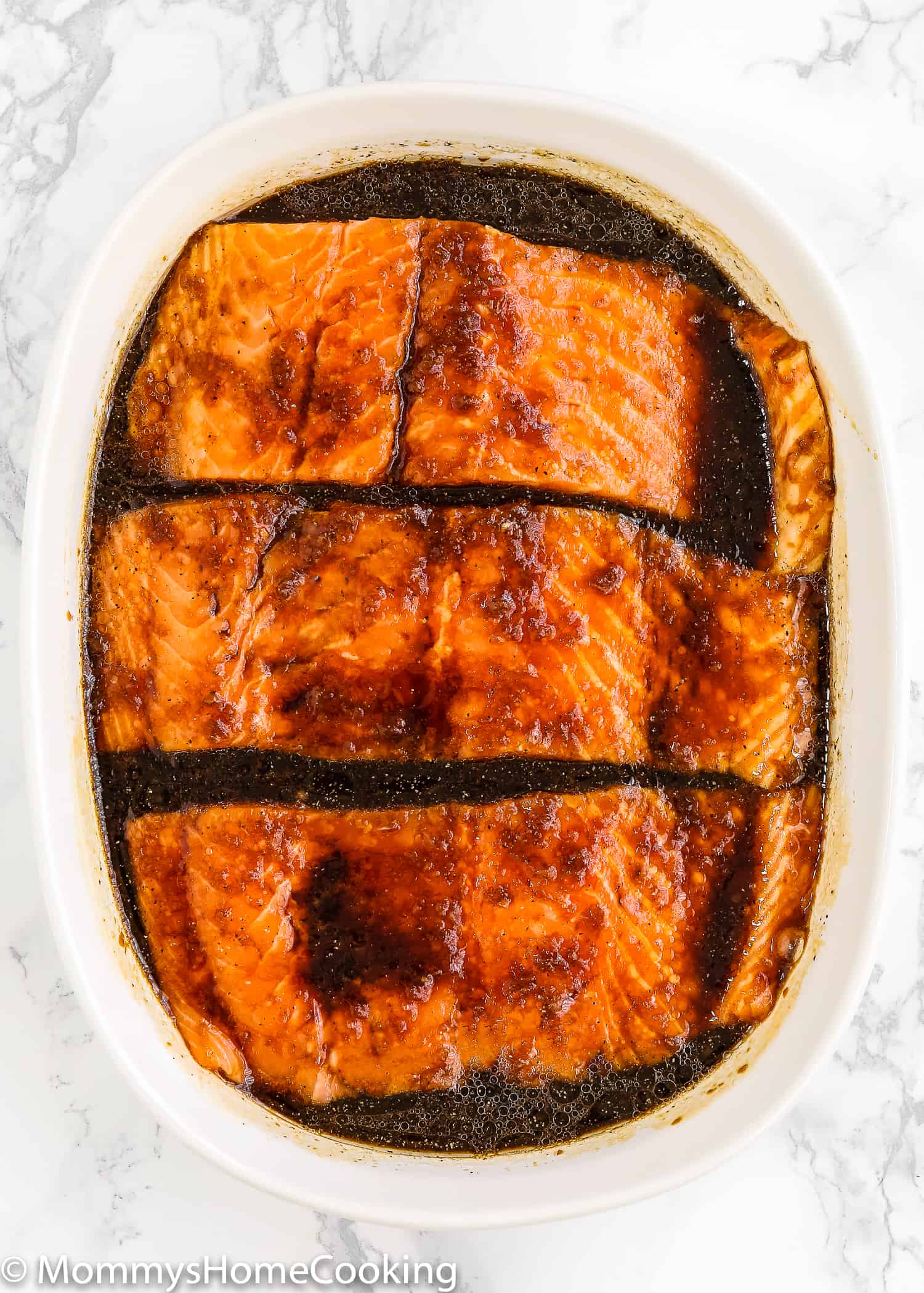 salmon fillets and teriyaki sauce in a bowl 