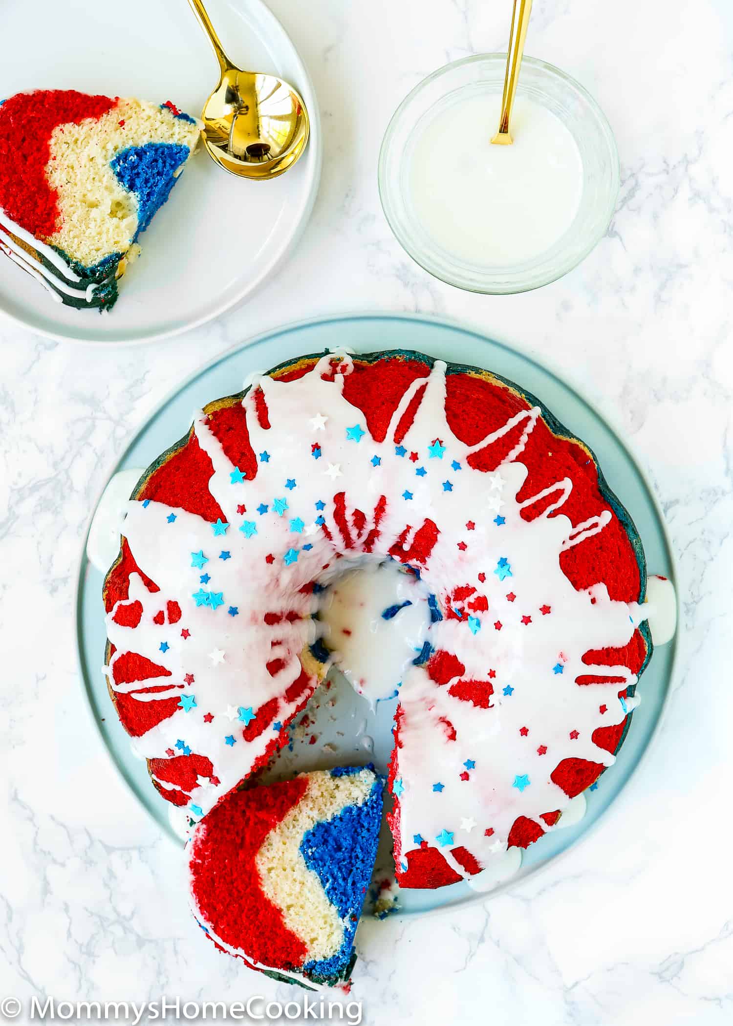 Red, White, and Blue Eggless Bundt Cake served on a plate with a golden spoon.
