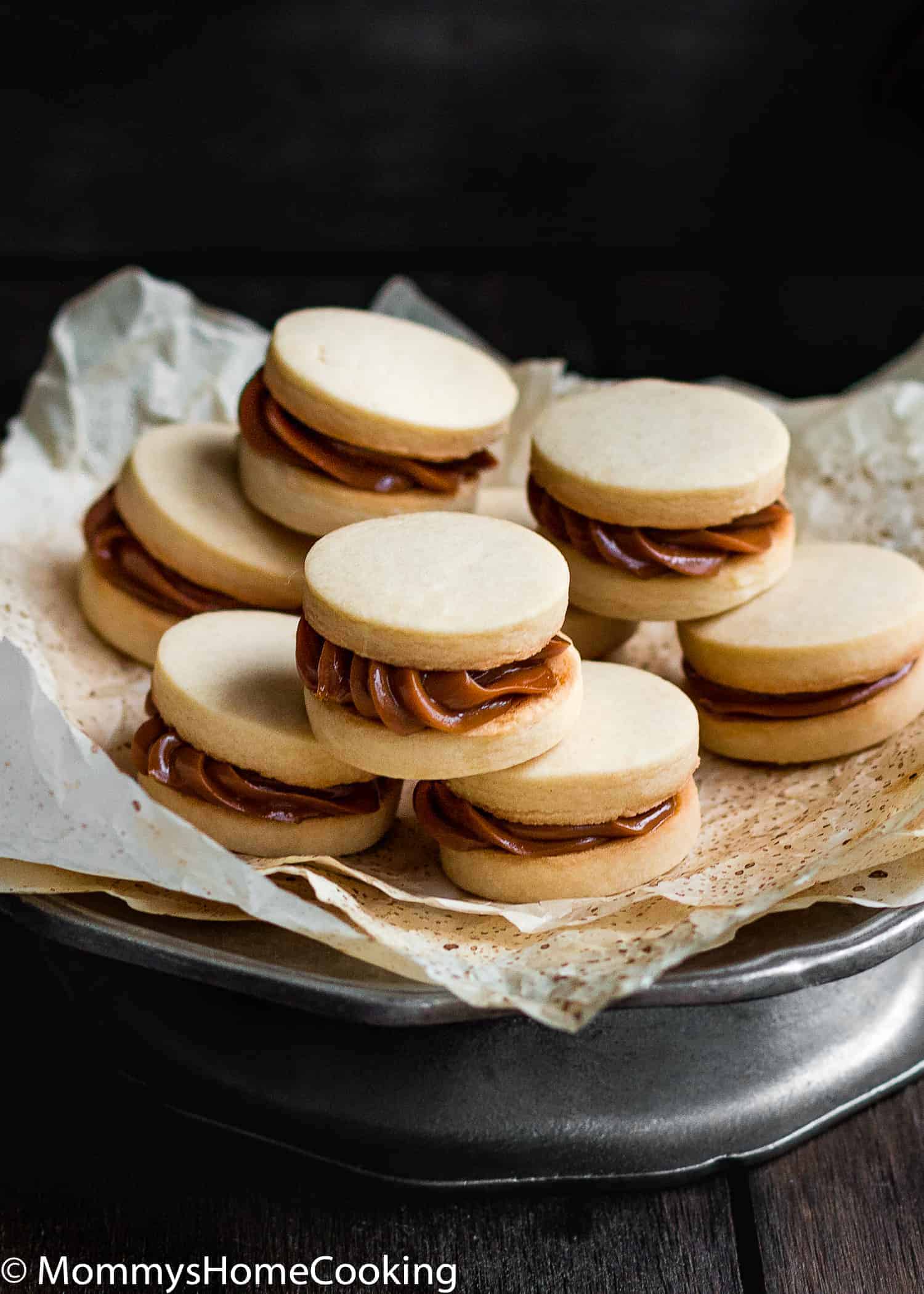 What is better than a cookie? A Sandwich Cookie!! These Eggless Dulce de Leche Shortbread Sandwich Cookies are buttery, rich incredibly tender and delicious. 9 filling ideas included. https://mommyshomecooking.com