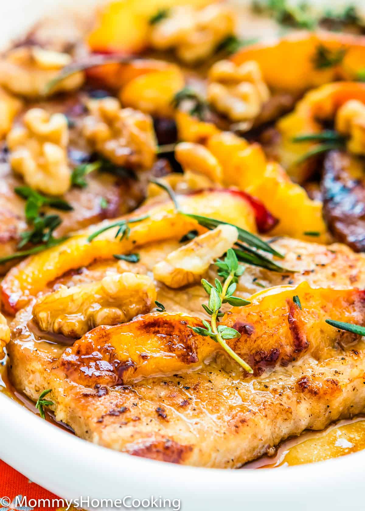grilled pork chops and peaches in a skillet