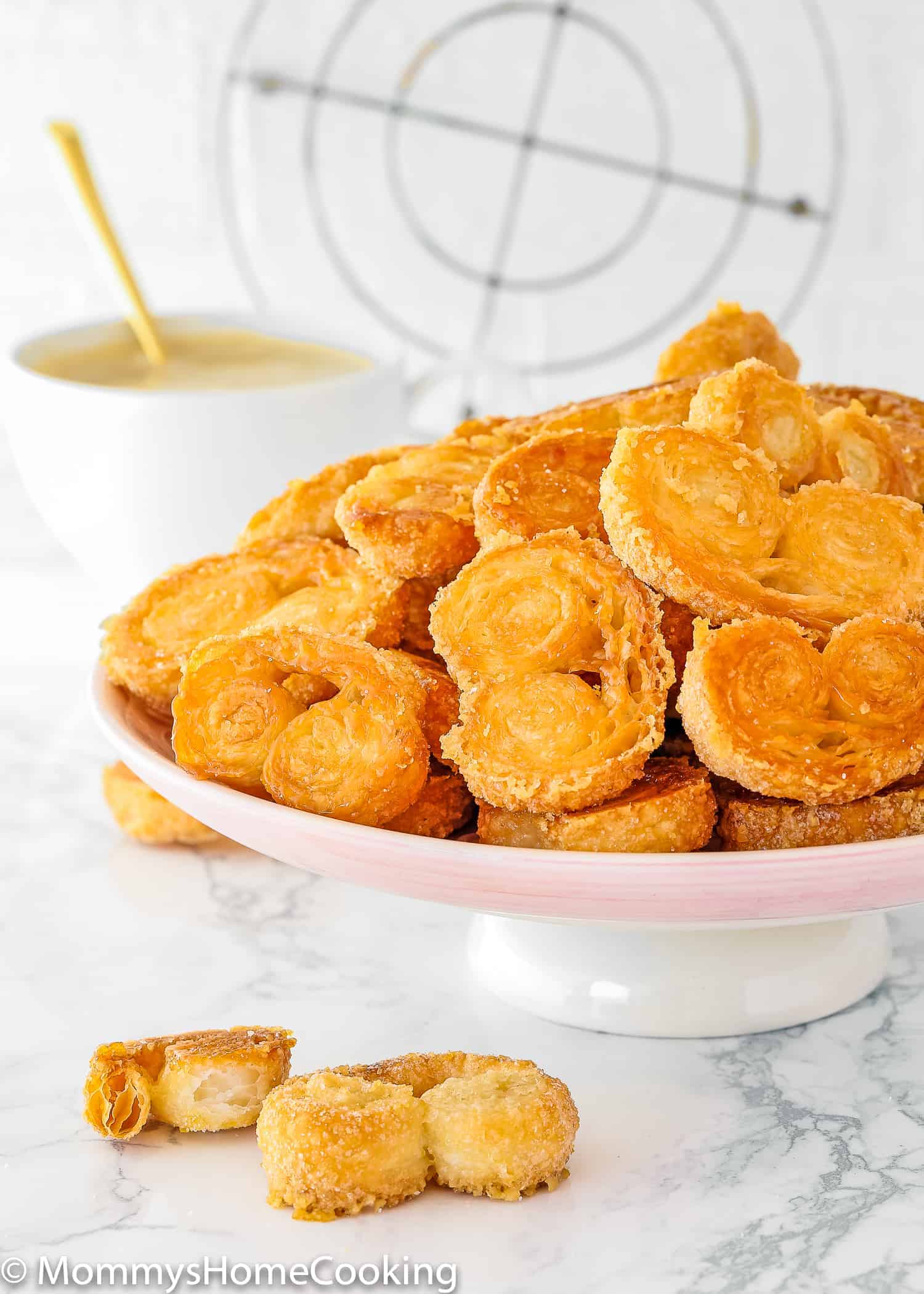 Easy Homemade Palmiers on a pink cake stand.